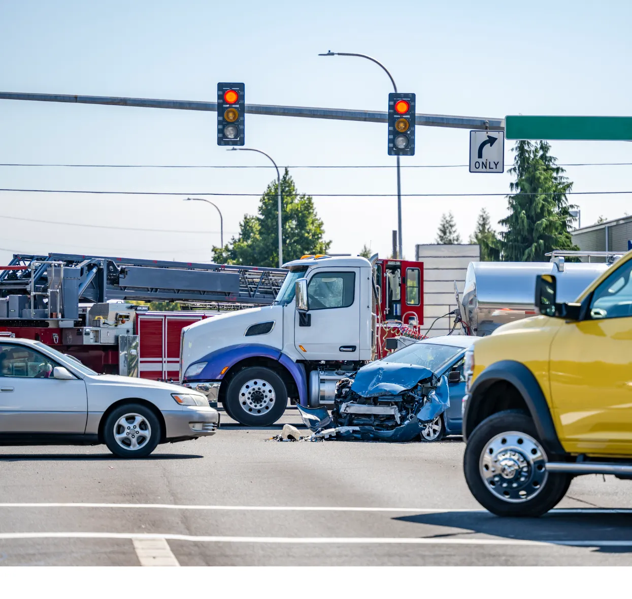 A car and commercial truck in an accident in an intersection. 