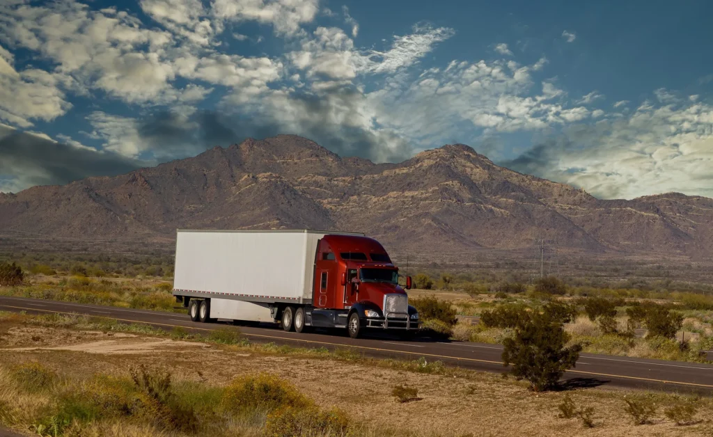 A semi-truck driving along the highway.