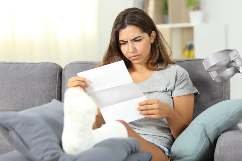 An injured woman reviewing paperwork.