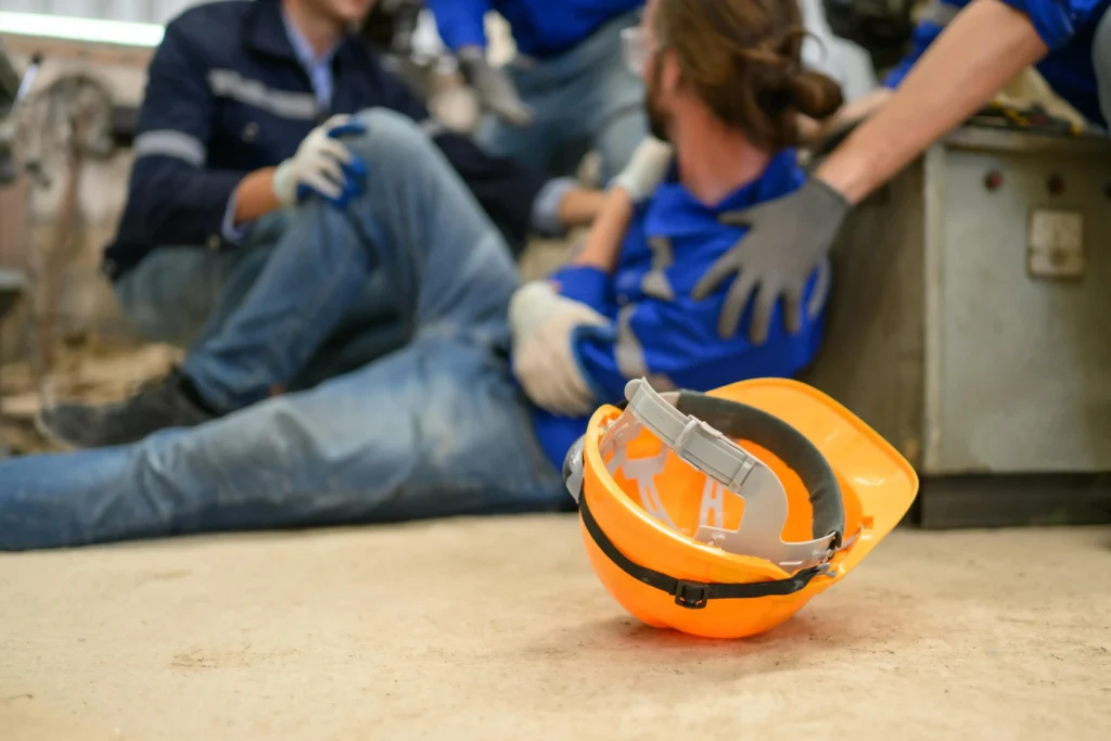 An injured worker holding his arm.