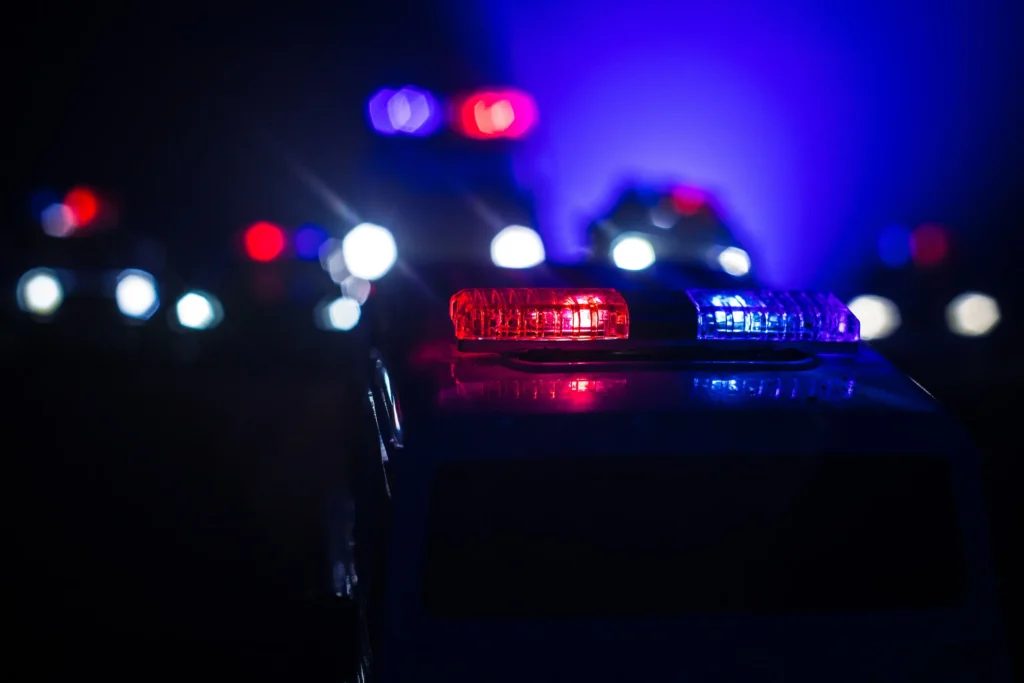 Police lights shining against a dark sky.